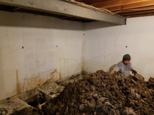 Digging pier installation holes in basement