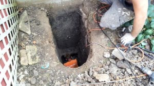 Man in deep hole installing foundation pier