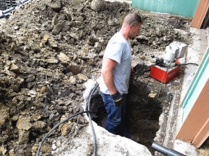 Man working in pier installation hole