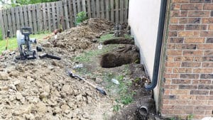 Two holes dug near house to install foundation piers
