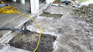 Two holes in a concrete patio