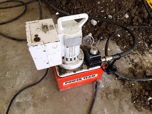 Foundation repair tool sitting on concrete