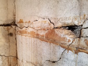 Gouge and cracks in concrete foundation wall