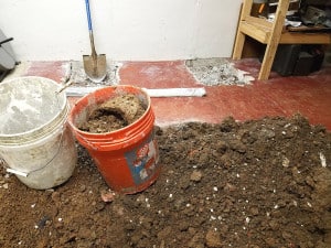Buckets filled with dirt in basement