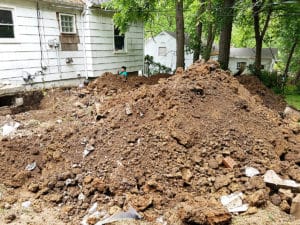 Large pile of dirt outside house