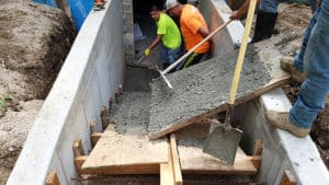 Pouring concrete down wooden ramps