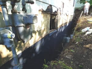 Foundation wall straightened to support house