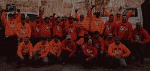 Foundation 1 crew cheering in orange sweatshirts