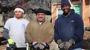 Three foundation 1 employees smiling with shovels