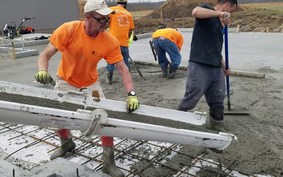 Men pouring concrete