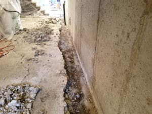 Trench near basement wall filled with gravel