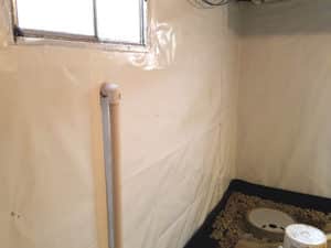 Sump pump pipe in wall