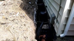 Fixing a foundation in a trench beside house