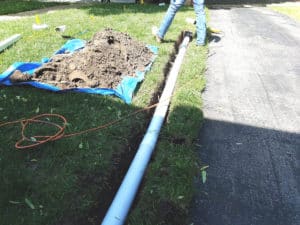 Pipe being installed into ground to drain water