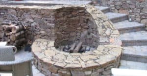 image showing fire pit uniquely designed to fit into a retaining wall and stair structure