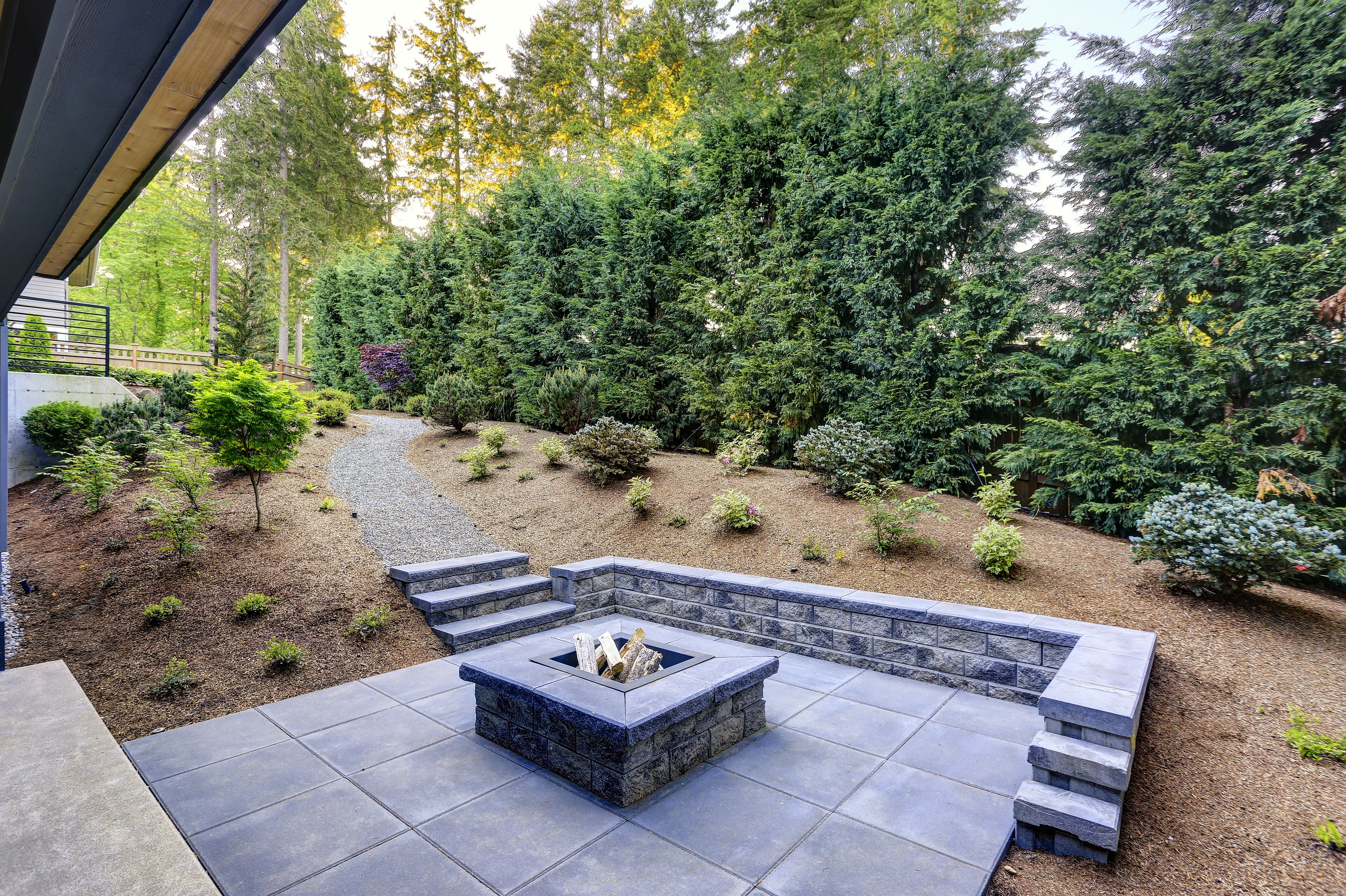 New Modern Home Features A Backyard With Fire Pit