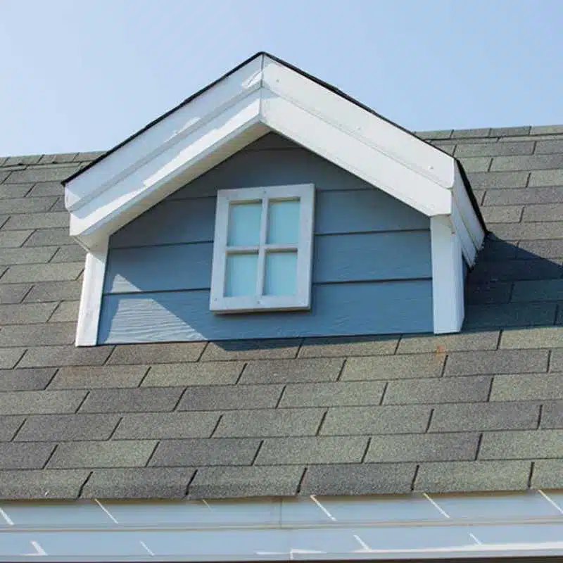 Roof dormer with window on a shingled residential roof