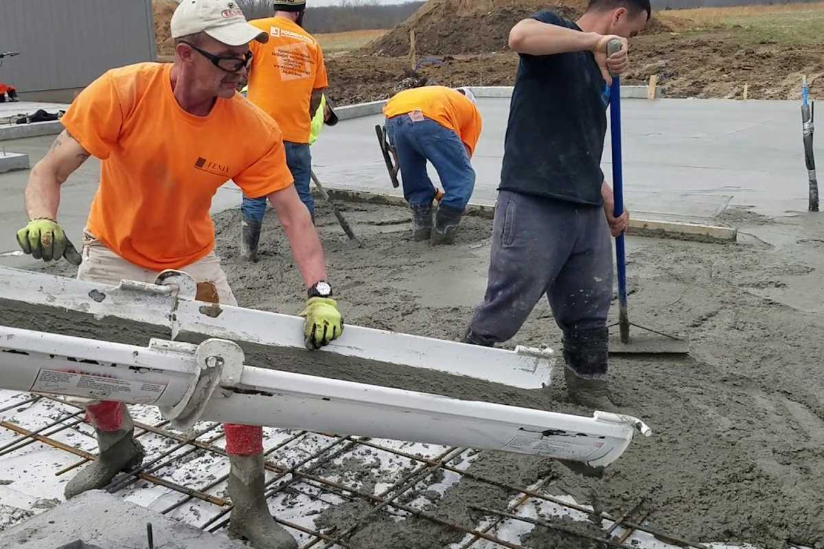 Workers performing foundation concrete repair