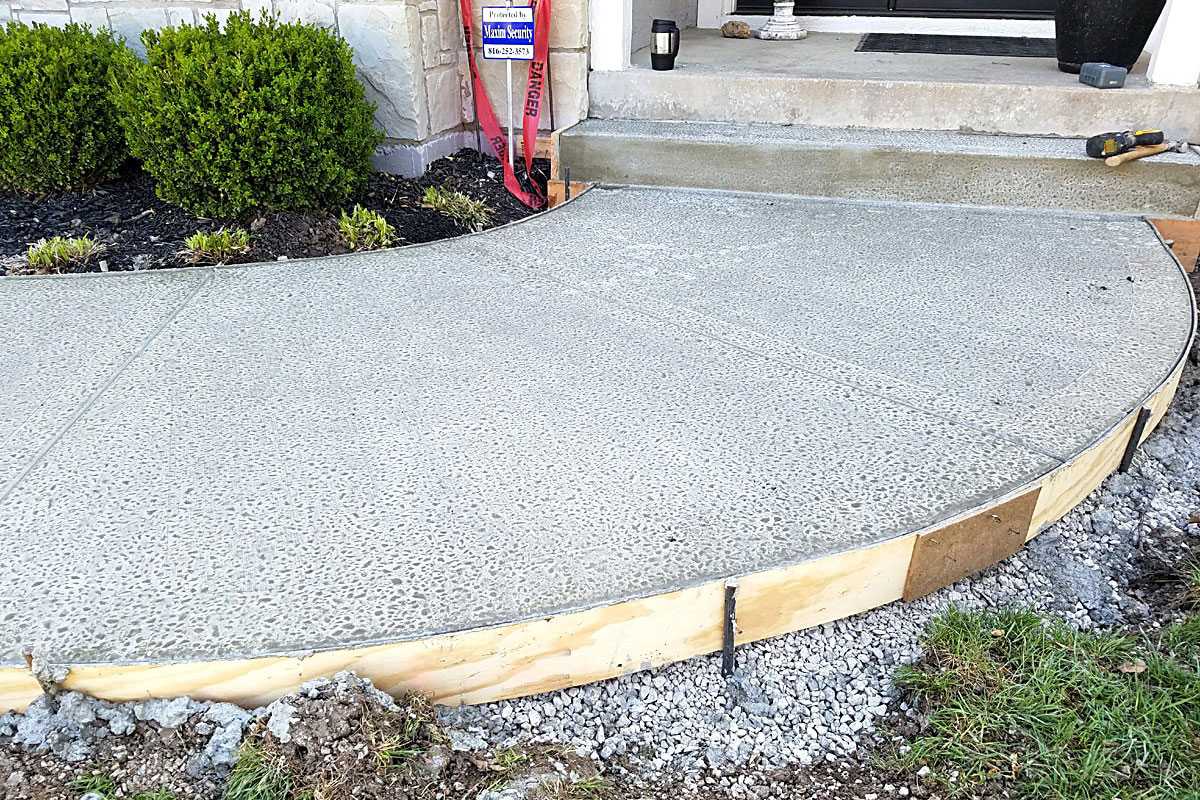 Circular concrete patio being releveled using polyjacking method