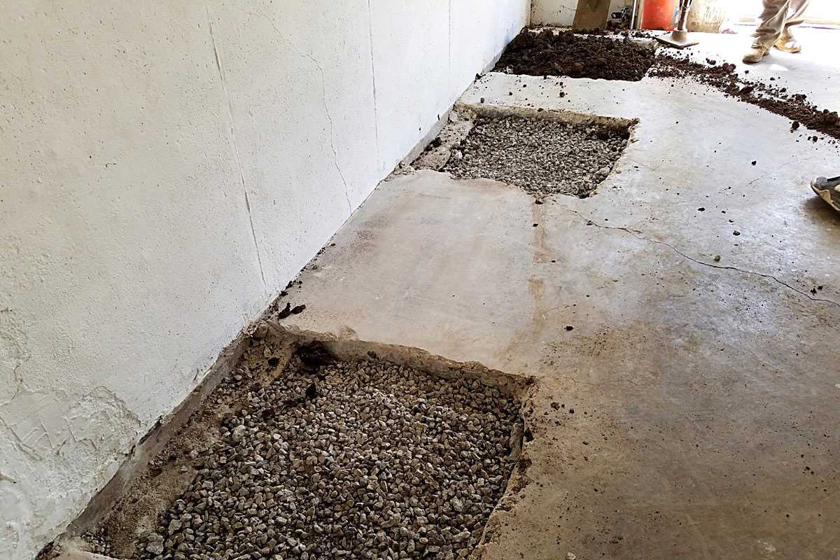 Cracked concrete slab being repaired with patching material
